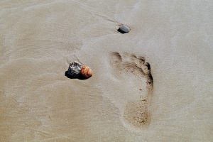photo of footstep on sandy beach